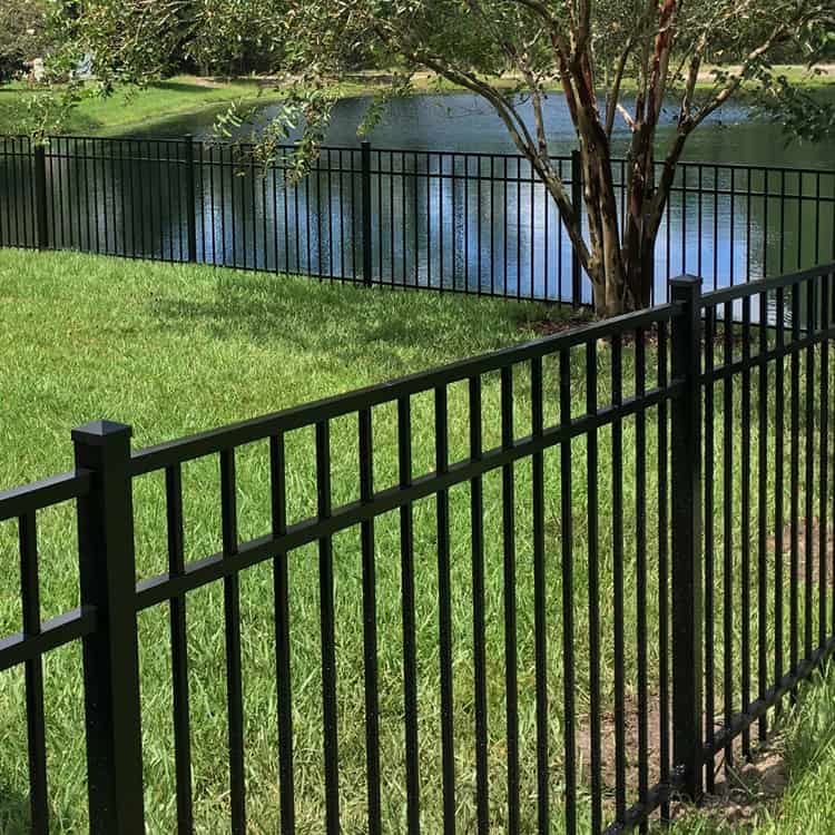 black aluminum fence with lake in the background