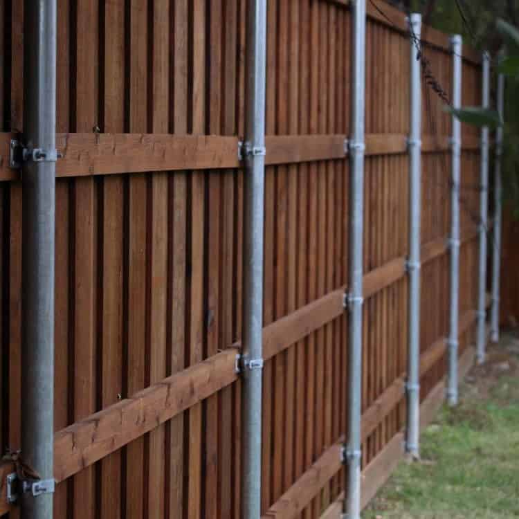 Grapevine fence repair dark stained wood privacy fence