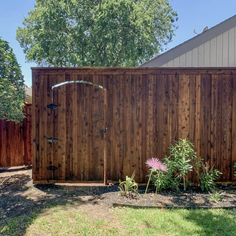 Pearland Fence Company dark stained wood fence with gate door