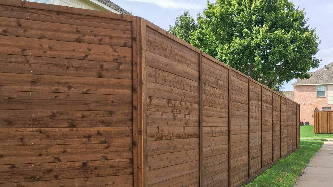 Cypress Gardens fence builder dark stained wood fence